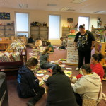 Maxwell Volunteers sorting picture books by author.